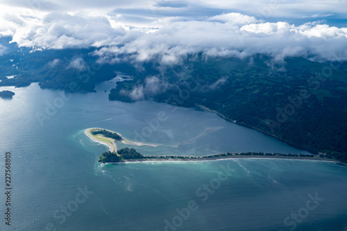 View of a spit of land near Seldovia Alaska, in the Kasitsna Bay. Aerial photography view with clouds and mountains photo
