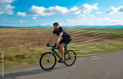 Casual hipster cyclist riding bicycle with high speed concept