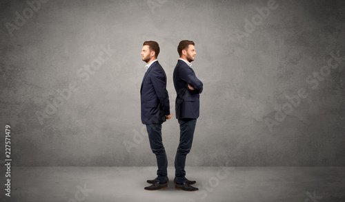 Young conflicted businessman choosing between two directions