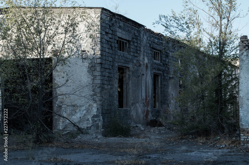 Abandoned ruined building of an old factory house broken walls non-residential premises for design background