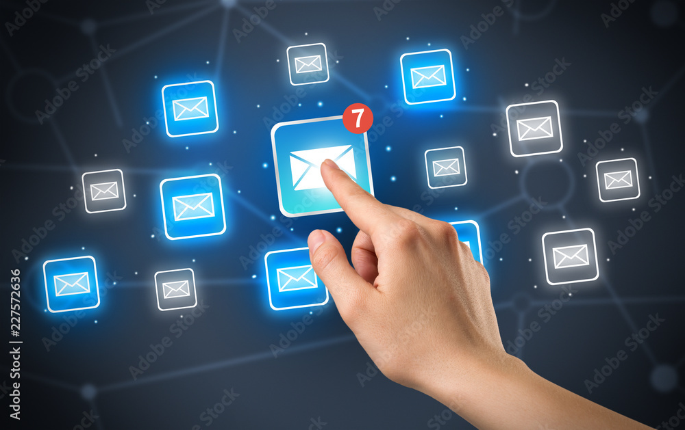 Female hand touching unread mail icon with more envelope icons around it Female hand touching unread mail icon with more envelope icons around it