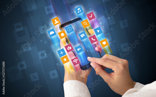 Female hand using smartphone with colorful angular fast switching application icons around photo