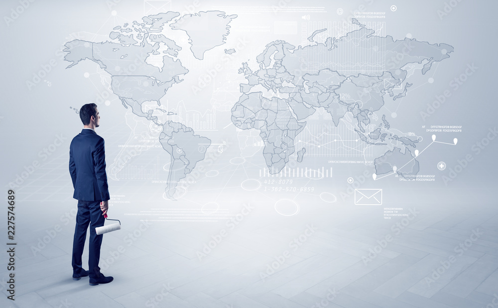 Businessman standing with his back and looking at a worldwide map with objects in his hand
Businessman standing with his back and looking at a worldwide map with objects in his hand