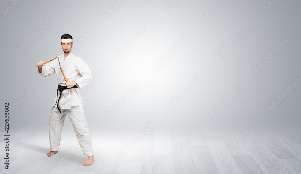 Young kung-fu trainer fighting in an empty space
Young kung-fu trainer fighting in an empty space