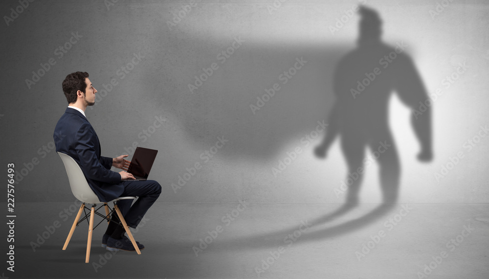 Humble businessman staying and offering stuffs to a superhero shadow
Humble businessman staying and offering stuffs to a superhero shadow
