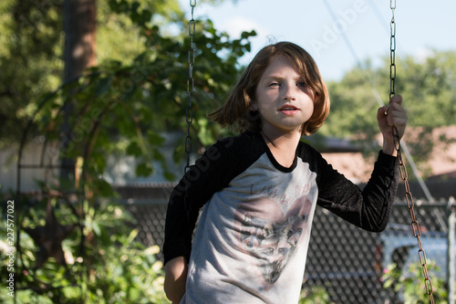 Pretty Young Girl Playing on Swing