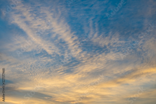 blue sky with flurry yellow gold clouds