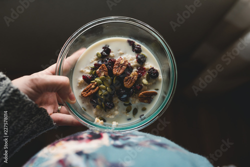 Pregnant woman holding a bowl of steel cut oats photo