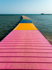 Fotobehang Roze Houten pad naar de zee  © rninov