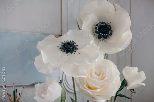 Big artificial decorative flowers in artist's workshop