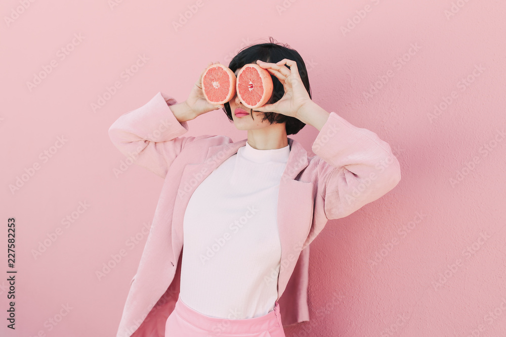 Girl in pink with grapefruit