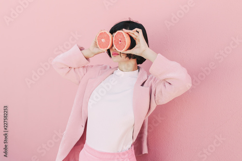 Girl in pink with grapefruit photo