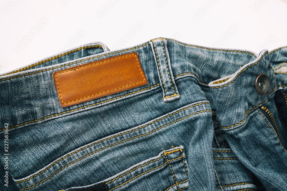 Blue jeans pants with back pocket and empty brown leather tag