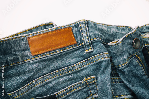 Blue jeans pants with back pocket and empty brown leather tag