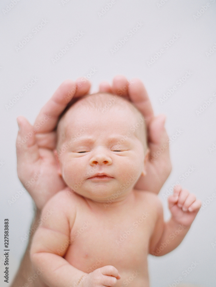 newborn sleeping in father's hands newborn sleeping in father's hands