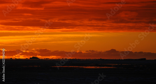 Sunset over sea-ice and icebergs, Antarctica