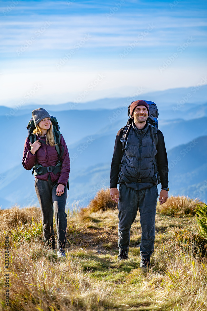 The happy man and a woman walking on the mountain The happy man and a woman walking on the mountain