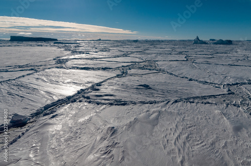 Thick snow-covered pack-ice and trapped icebergs  Antarctica