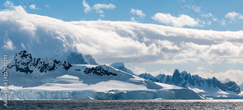 Rolling clouds over snow-capped mountains and ice cliffs, Antarctic Peninsula