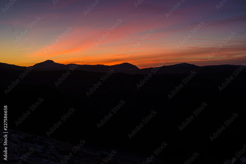 Sunset against mountain landscape Sunset against mountain landscape