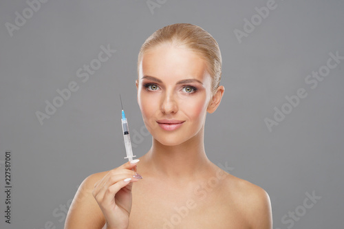 Beauty injection in a face of a young woman. Plastic surgery concept.