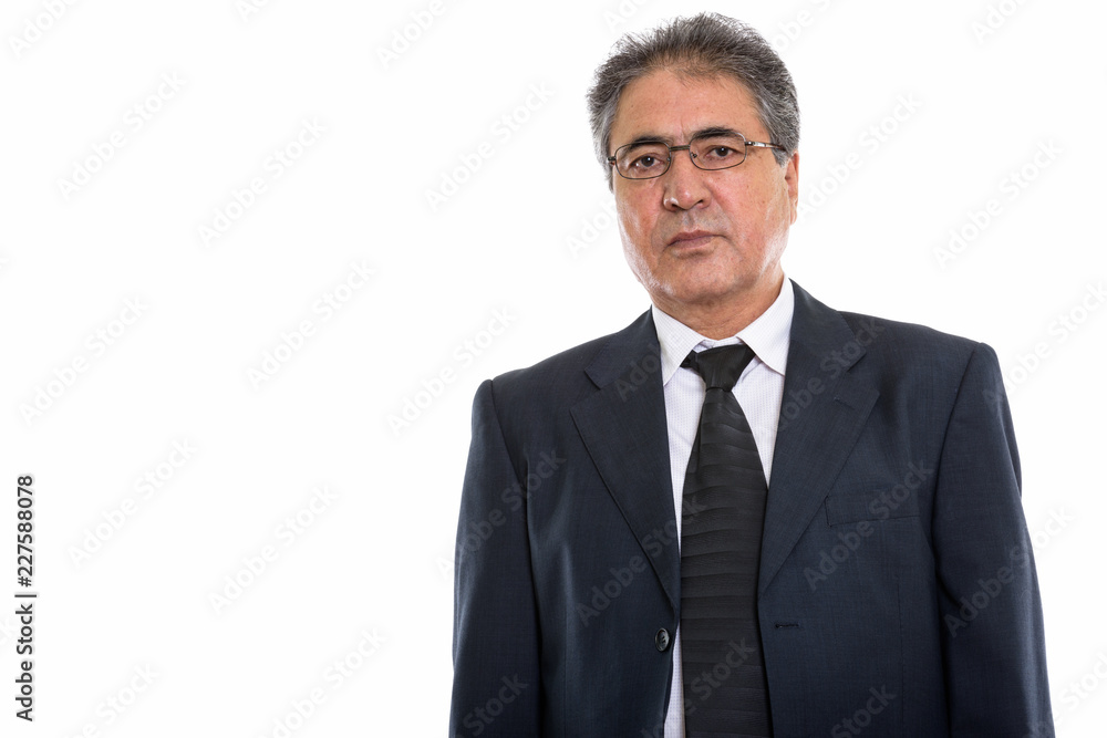 Studio shot of senior Persian businessman wearing eyeglasses Studio shot of senior Persian businessman wearing eyeglasses