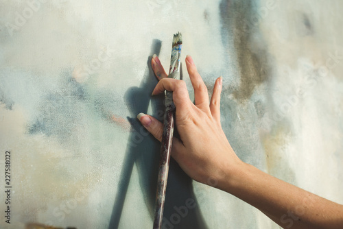 Close up of an artist's hand with brush