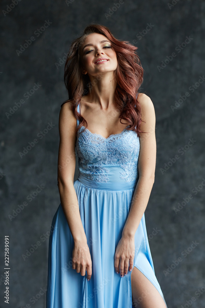 Beautiful girl with make up and hair in long blue dress Beautiful girl with make up and hair in long blue dress