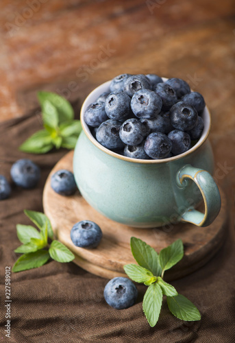 blueberry in a cup on a wooden background