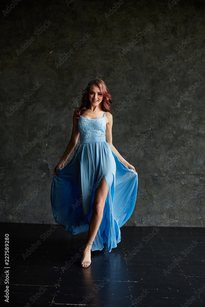 Beautiful girl with make up and hair in long blue dress Beautiful girl with make up and hair in long blue dress