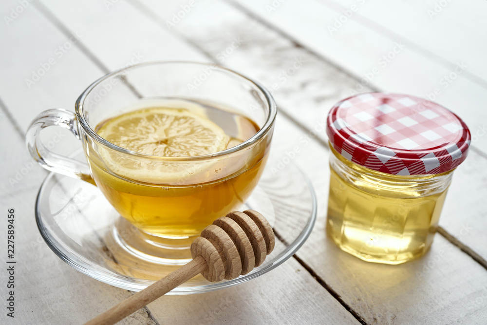 delicious hot tea with lemon and honey on an old white wooden table delicious hot tea with lemon and honey on an old white wooden table