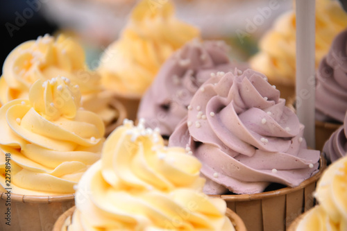 Close up Cup Cake vanilla cream topping pastel colour event on shelve decoration