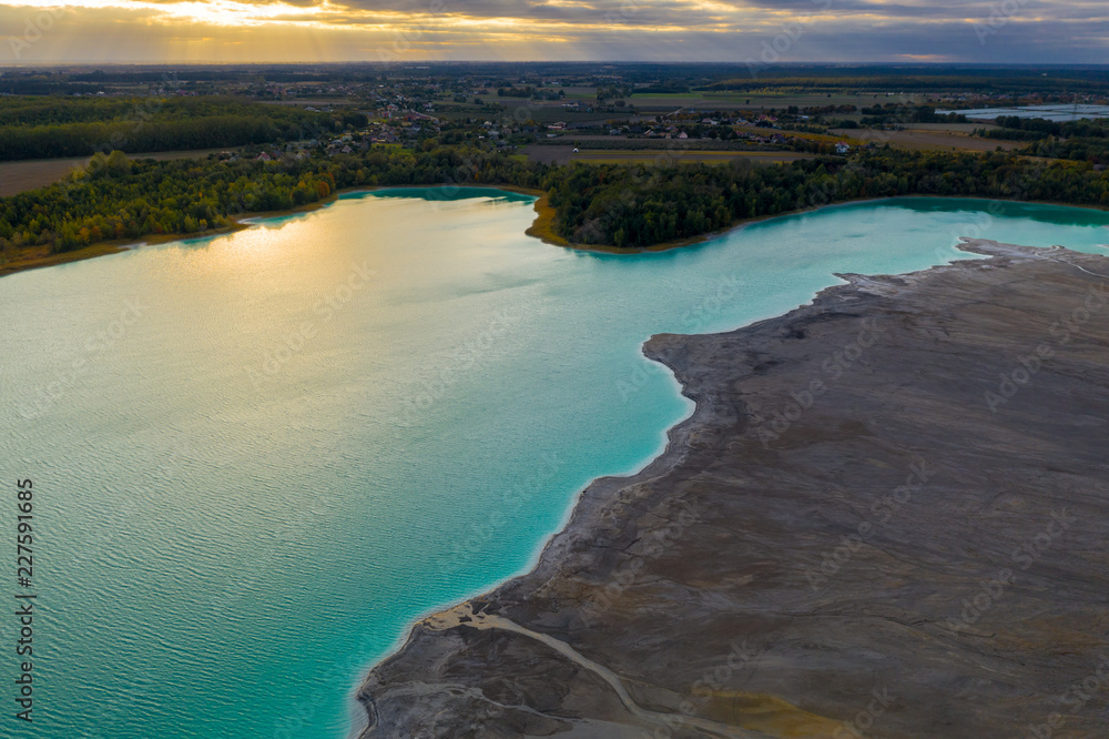 Turquoise water of lake powered by power plant mineral waste. Aerial view.