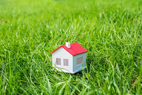 House model on the grass / building a green home