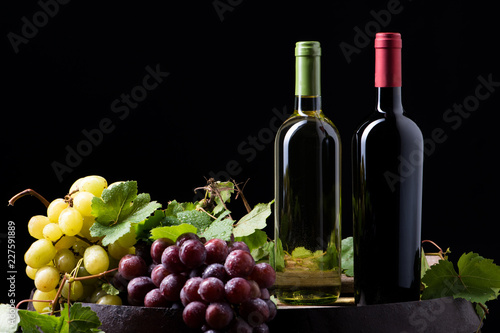 Wine bottles and a glass on a barrel