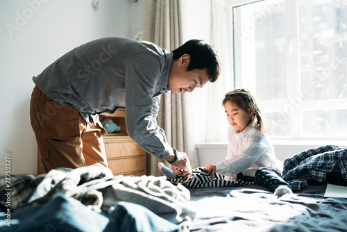 Asian family folding laundry at home