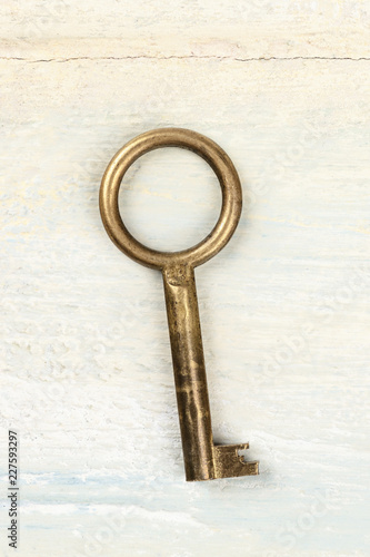 A top shot of a vintage key on light background with copyspace