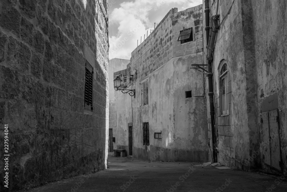 An old narrow street in Siggiewi, Malta in black and white
