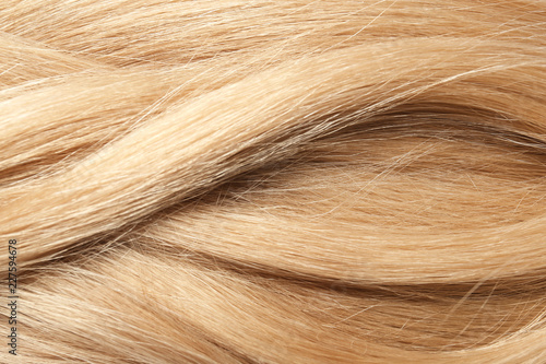 Texture of healthy blond hair as background, closeup