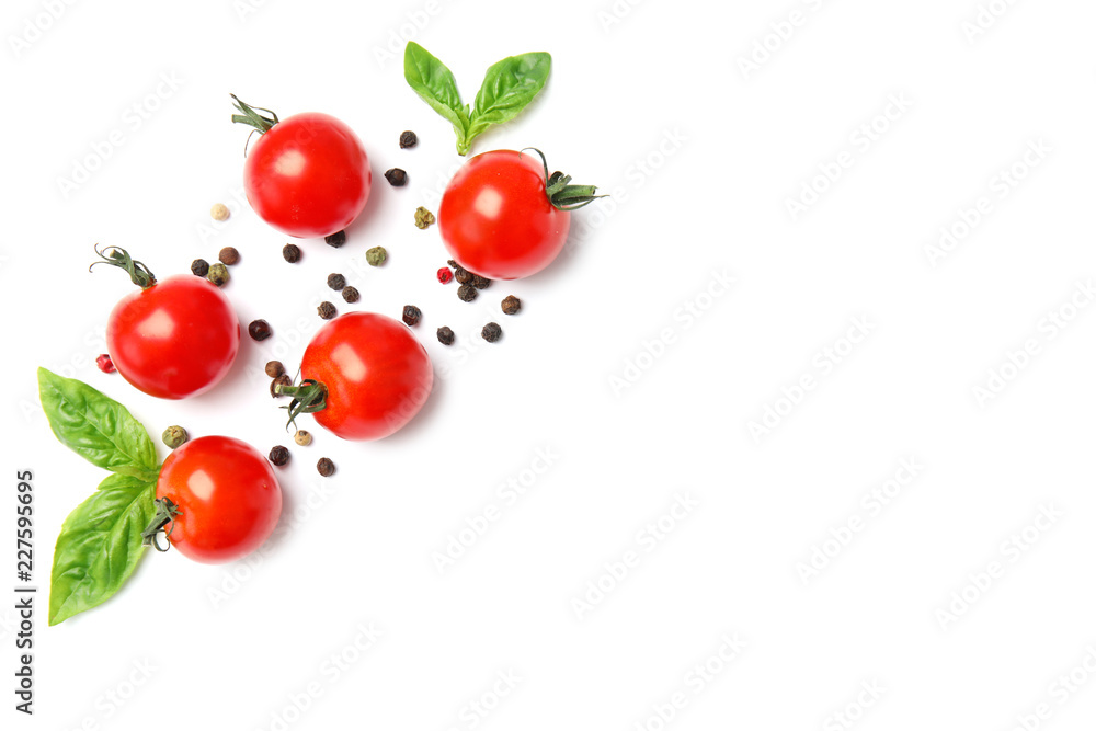 Fresh green basil leaves and cherry tomatoes on white background, top view Fresh green basil leaves and cherry tomatoes on white background, top view