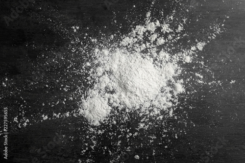 Scattered wheat flour on gray background, top view