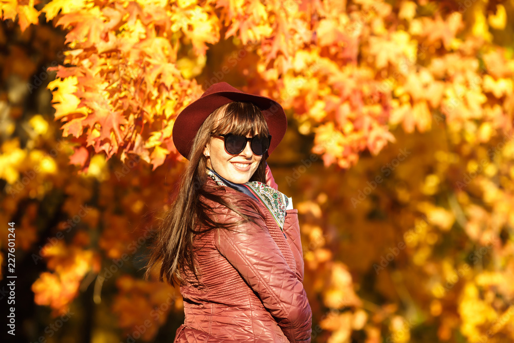 Outdoor close up portrait big size model beautiful brunette girl with hat and sunglass looking at camera in autumn forest as background Outdoor close up portrait big size model beautiful brunette girl with hat and sunglass looking at camera in autumn forest as background