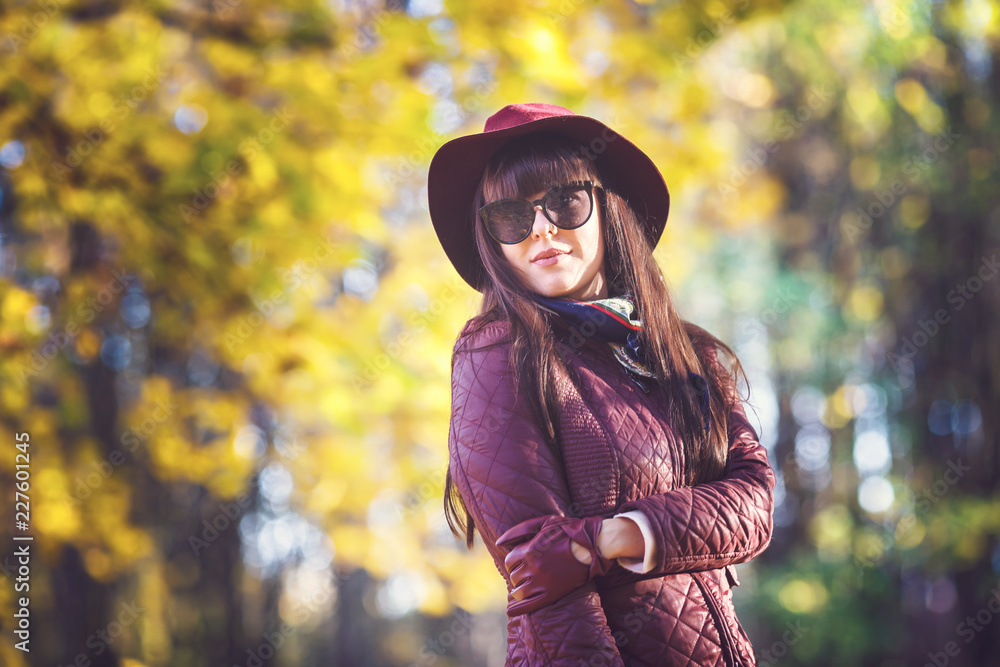 Outdoor close up portrait big size model beautiful brunette girl with hat and sunglass looking at camera in autumn forest as background Outdoor close up portrait big size model beautiful brunette girl with hat and sunglass looking at camera in autumn forest as background