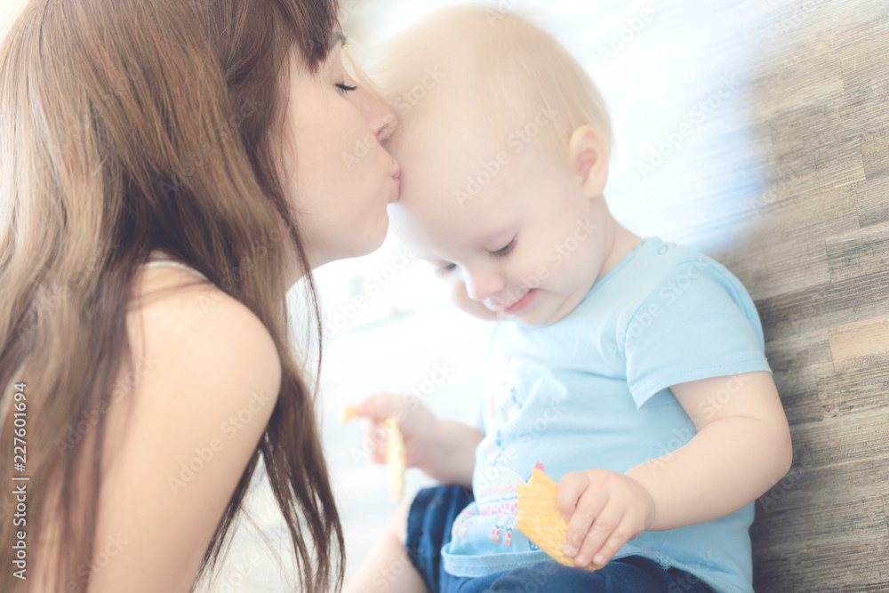 Portrait of beautiful mother kissing her child girl Portrait of beautiful mother kissing her child girl