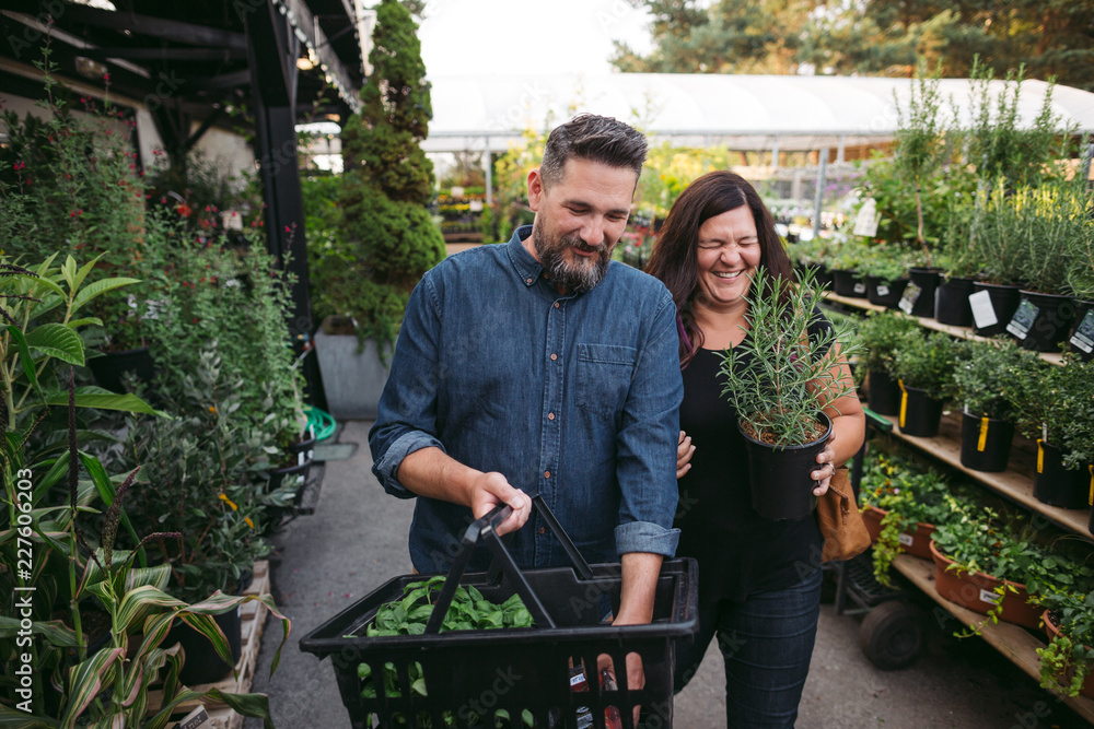 Couple enjoying doing groceries together at local market Couple enjoying doing groceries together at local market