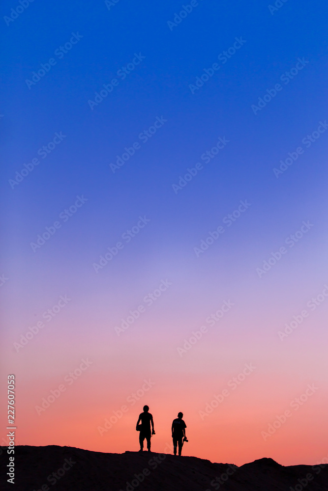 Two people on the top of mountain in sunset Two people on the top of mountain in sunset