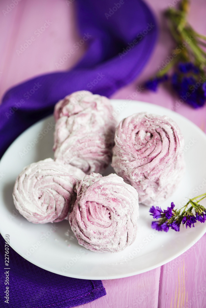 pink fruit marshmallow on a plate on a wooden background pink fruit marshmallow on a plate on a wooden background