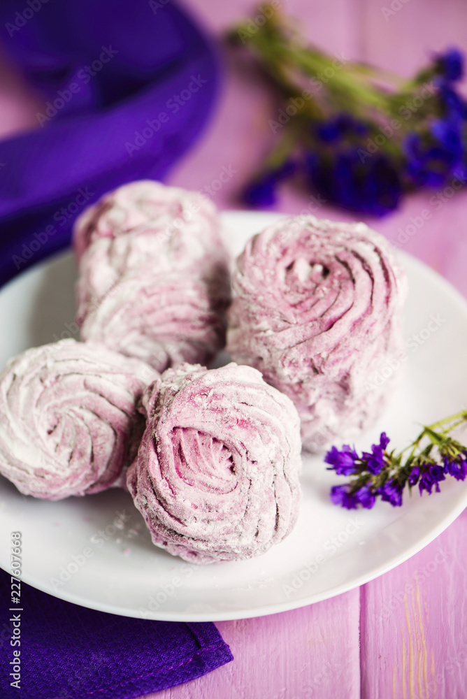 pink fruit marshmallow on a plate on a wooden background pink fruit marshmallow on a plate on a wooden background