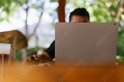 Man On His Laptop Working Remotely While On Vacation photo