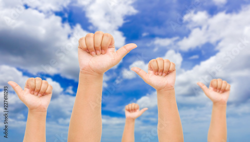 human hand gesture something with sky background